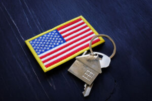 house keychain, key, and American flag patch sits on table American VA Loans